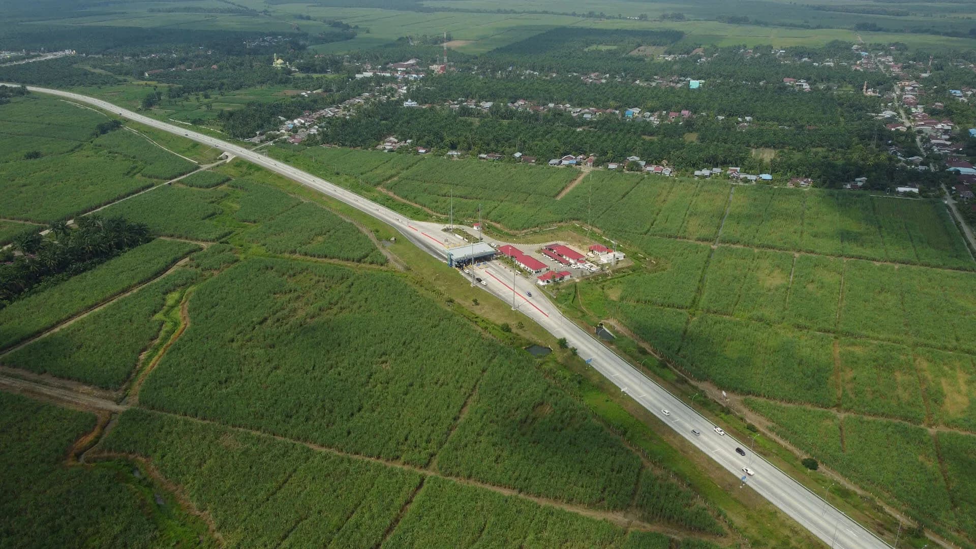 Gerbang tol ruas Binjai–Pangkalan Brandan di tengah lahan pertanian