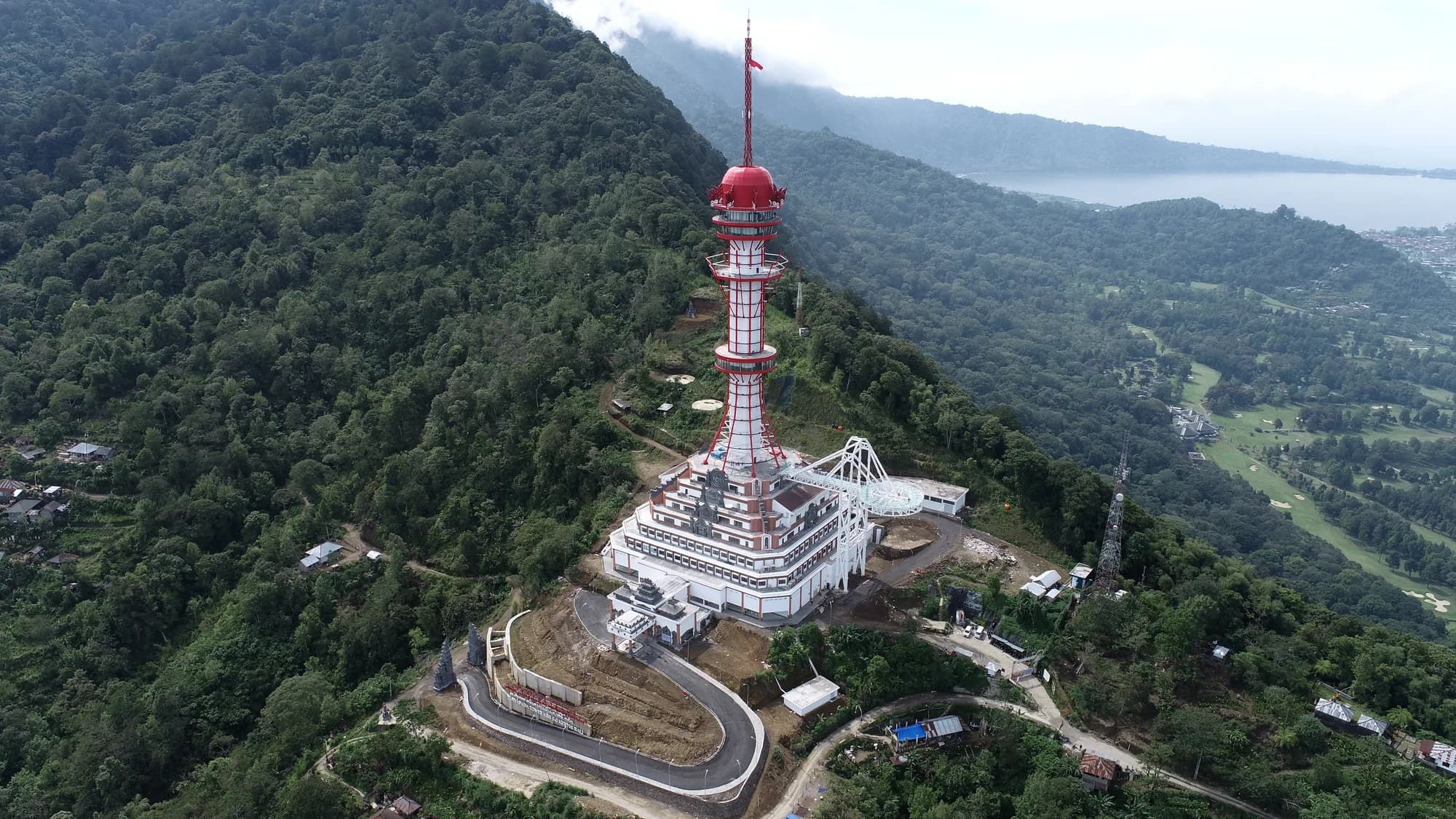Menara Turyapada berdiri di puncak perbukitan berhutan